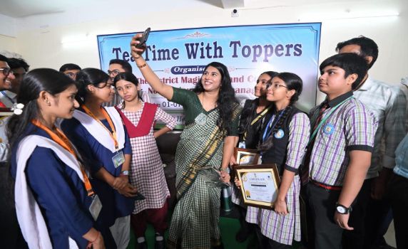 North Tripura DM Chandni Chandran takes selfie with toppers of Board exams during 